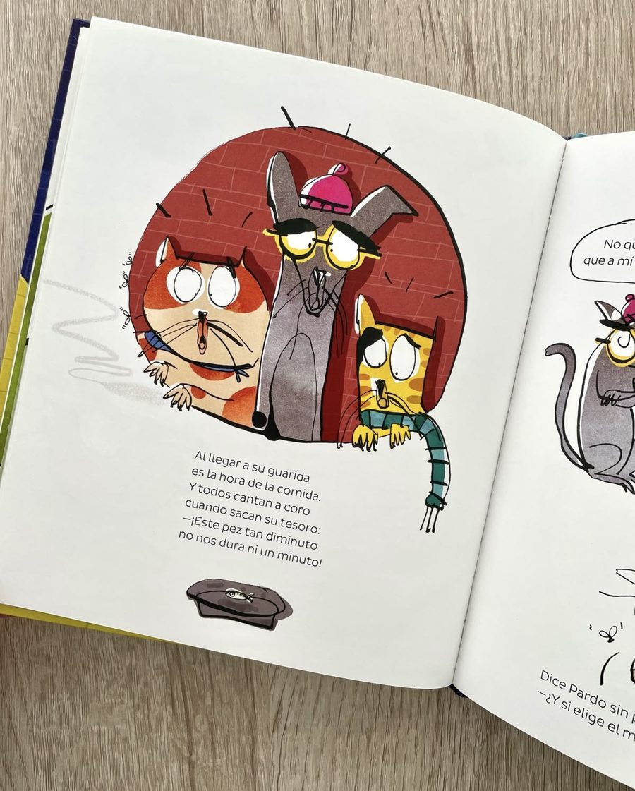 Picture book page with a circular illustration of three cats and a short verse below
